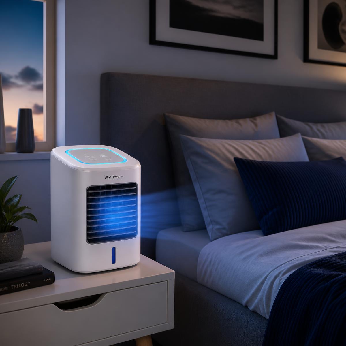 Mini air conditioner on a bedside table at night